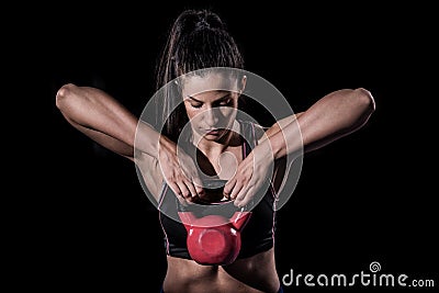 Woman bodybuilder lifting weight isolated over black background Stock Photo