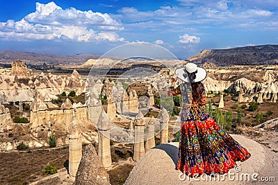 Woman in Bohemian dress standing on Love Valley in Cappadocia, Turkey. Stock Photo