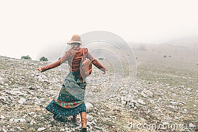 Woman in boho clothing traveling in fog weather Stock Photo