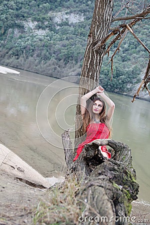 Woman in a bold red dress like a little red riding hood Stock Photo