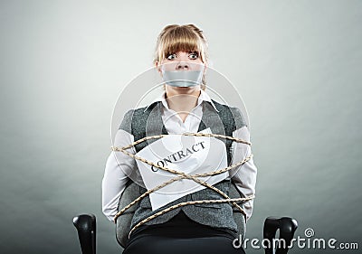 Woman bound by contract terms with taped mouth. Stock Photo