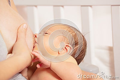 Woman breastfeed newborn infant with focus on baby face, Stock Photo