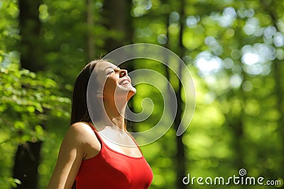 Woman breathing fresh air in the forest Stock Photo