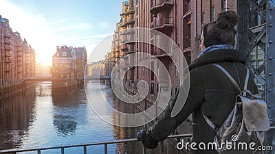 Woman on Bridge across channel in old warehouse district in Hamburg Stock Photo