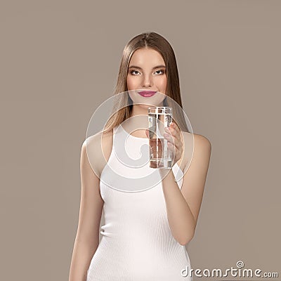 Woman with bright make-up in a beautiful white dress. Smiling girl Mineral water Stock Photo