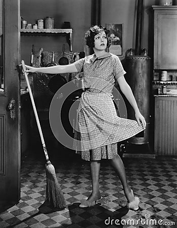 Woman with broom Stock Photo