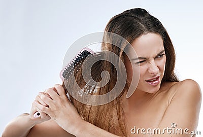 Woman, brush and pain for hair in studio with mockup for beauty, wellness and shine on white background. Model Stock Photo