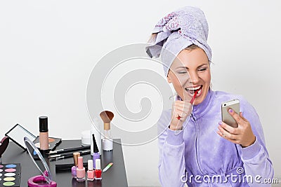 Woman brushing her teeth and talking on the phone Stock Photo