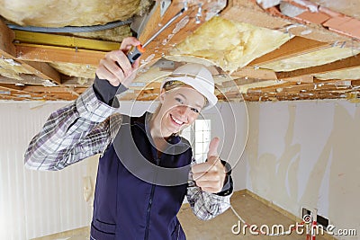 Woman builder architect shows thumb up Stock Photo