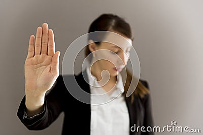 Woman in business suit showing her palm, body language, say NO a Stock Photo