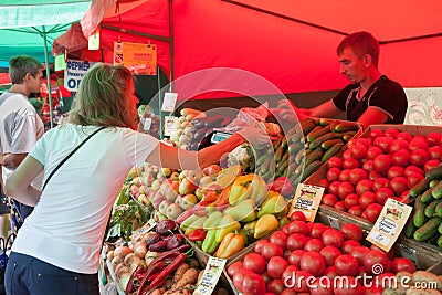 A woman buying fruit in Vegetable Fair Editorial Stock Photo