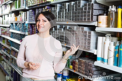 Woman buying hair colourant in store Stock Photo