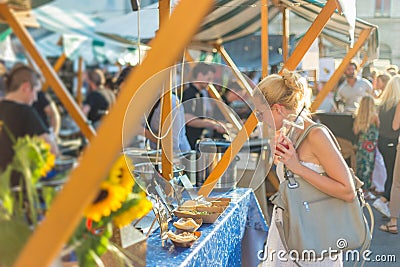 Woman buying meal at street food festival. Stock Photo