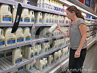 Woman Buys Australian Milk in a Supermarket Editorial Stock Photo
