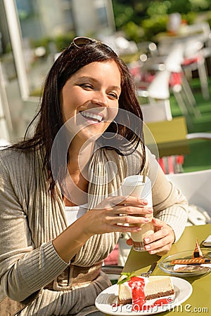 Woman at cafe bar holding latte drink Stock Photo