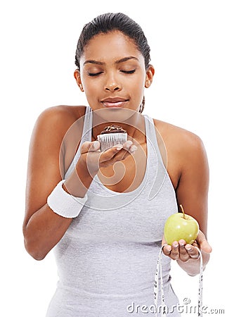 Woman, cake and fruit choice diet or smell dessert for weight loss, nutrition decision or balance food. Female person Stock Photo