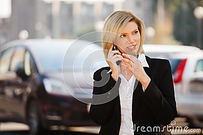 Blond fashion business woman calling on cell phone outdoor Stock Photo