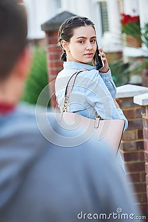 Woman Calling For Help On Mobile Phone Whilst Being Stalked On C Stock Photo
