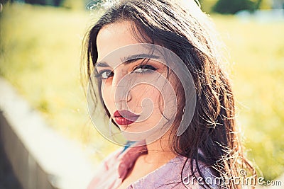 Woman on calm face with make up, nature on background, defocused. Girl with long hair wears unbuttoned shirt on sunny Stock Photo