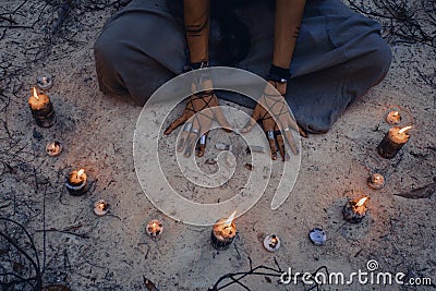 Woman with candle deep in forest. Witch craft Stock Photo