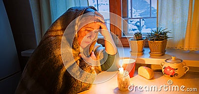 Woman with candles. Power outage in Kyiv Stock Photo