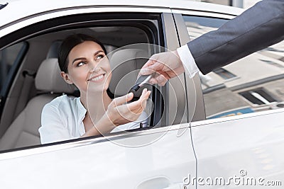 Woman at car dealership, buying new auto Stock Photo