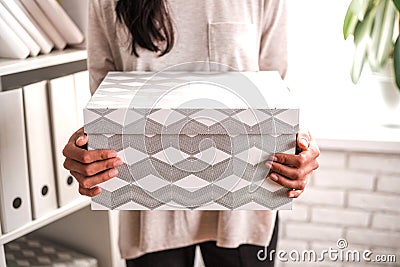 Woman with a cardboard box in hand. Stock Photo