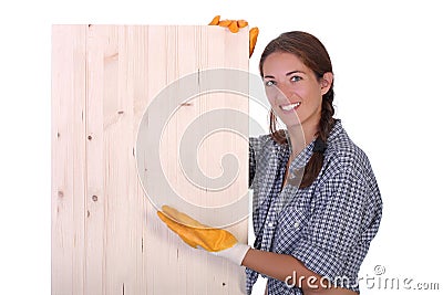 Woman carpenter holding wooden plank Stock Photo