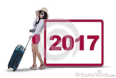 Woman carrying suitcase and digital indoor Stock Photo