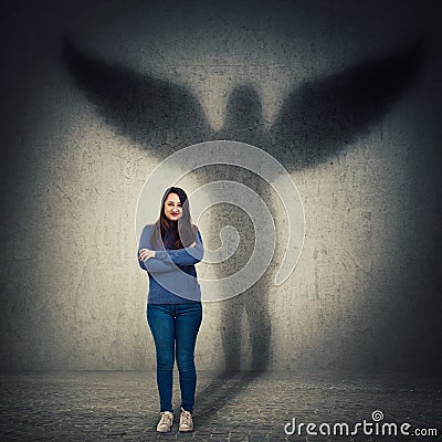 Woman casting angel shadow Stock Photo