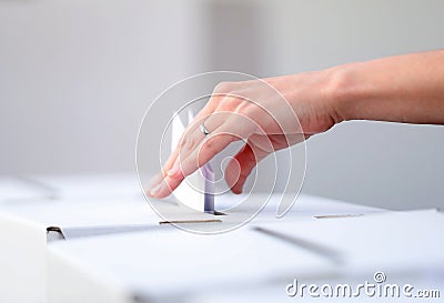 Woman casts her ballot at elections Stock Photo