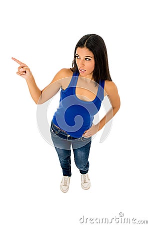 Woman in casual top and jeans pointing to copy space presenting product Stock Photo