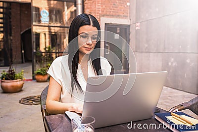 Woman in casual wear and glasses smart marketing coordinator having online training course via portable laptop computer Stock Photo