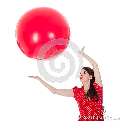 Woman catching big red balloon above her head Stock Photo