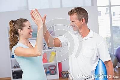 Woman celebrating with her trainer Stock Photo