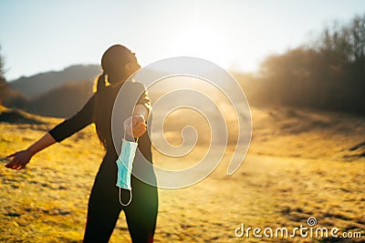 Woman celebrating without mask.Concept of defeating illness.Recovered from coronavirus.Cured disease emotional patient.Covid-19 Stock Photo