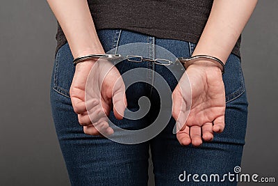 Woman chained in handcuffs back view Stock Photo