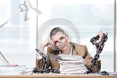 The woman chained to her working desk Stock Photo