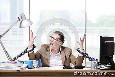 The woman chained to her working desk Stock Photo