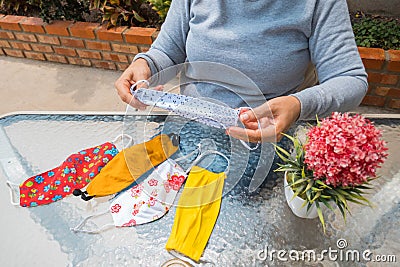 Woman checked face masks made by herself Stock Photo