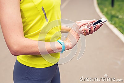 Woman checking fitness and health tracking wearable device Stock Photo