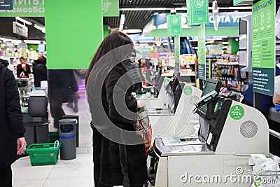 Woman at the checkout-self-service in the store. Moscow. 05.02.2019 Editorial Stock Photo