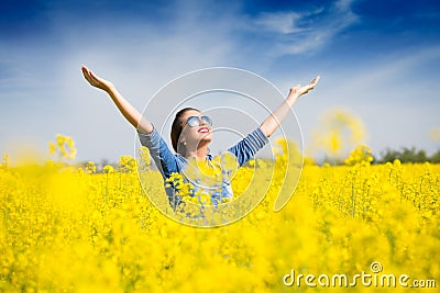 Woman cheering in the field Stock Photo