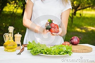 Woman chef holding fresh vagetables Stock Photo