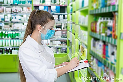 Woman chemist checking medication list in drugstore Stock Photo