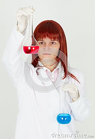 Woman chemist with colored flasks Stock Photo