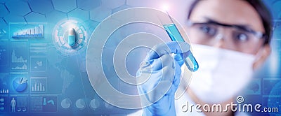 Woman chemist examining a test-tube with blue liquid while working at drugs synthesis in scientific background Stock Photo