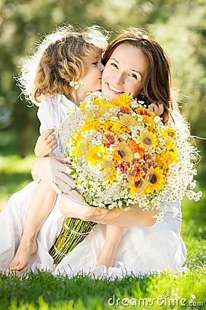 Woman and child holding bouquet of flowers Stock Photo