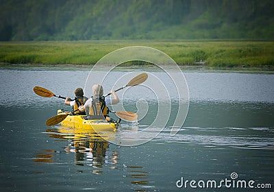 The woman with a child on the lake and ride on kayak Stock Photo