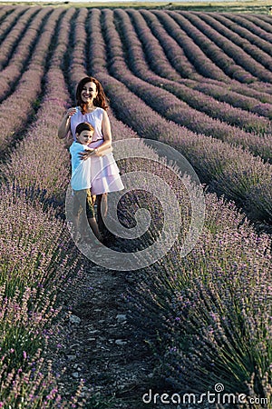 woman and child in lavender in purple flowers walk nature journey Stock Photo